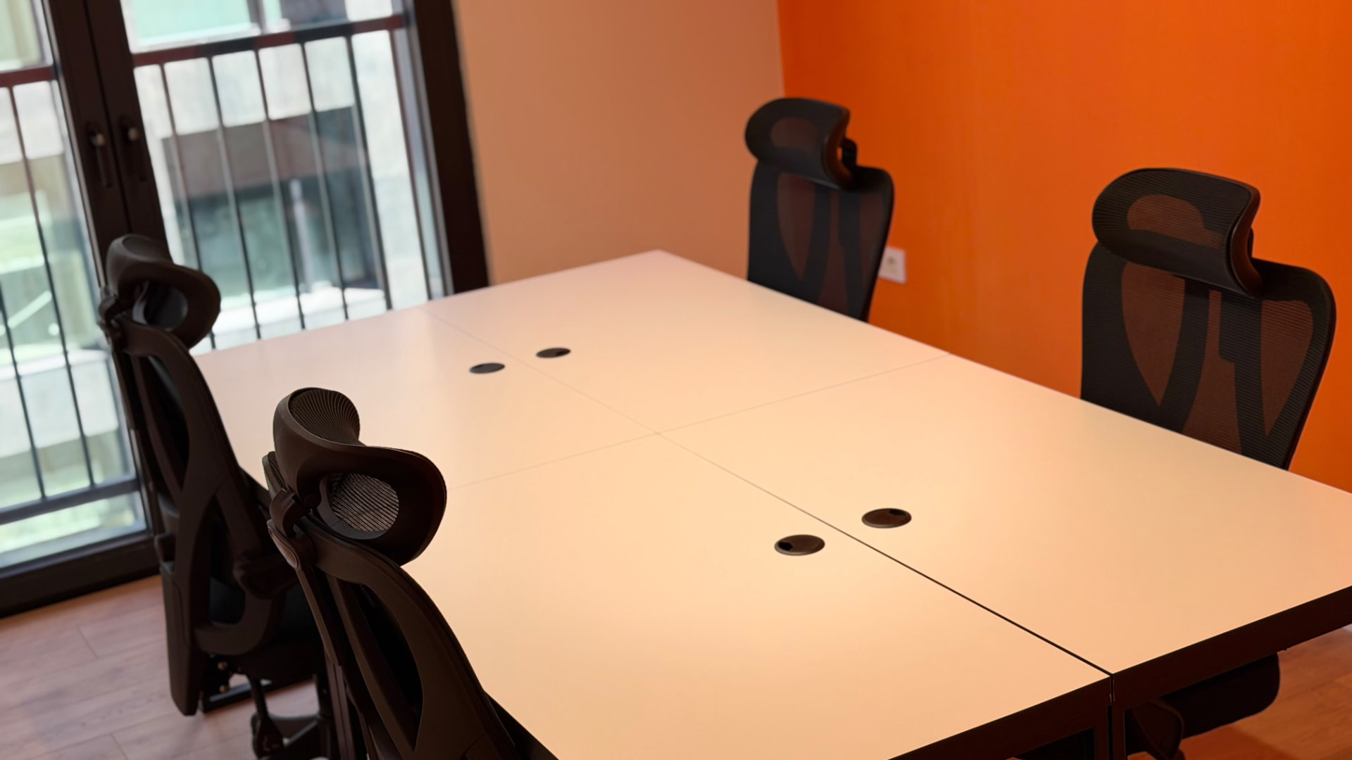 Close view of white meeting table and black chairs at PRN CO-WORK